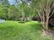 Lush backyard showcasing mature trees, a well-maintained lawn, and landscaped borders at 104 Tobe Bridge Rd, Kings Mountain, NC 28086