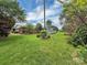 Expansive backyard featuring lush greenery, wooden deck, and colorful landscaping elements at 104 Tobe Bridge Rd, Kings Mountain, NC 28086