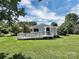 Backyard showcasing a well-maintained lawn, charming home, and a ramp at 104 Tobe Bridge Rd, Kings Mountain, NC 28086