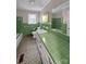 Retro bathroom with green tile, tub, and vanity with drawers and large mirror at 104 Tobe Bridge Rd, Kings Mountain, NC 28086