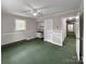 Spacious bedroom with a ceiling fan, built-in desk, and green carpet at 104 Tobe Bridge Rd, Kings Mountain, NC 28086