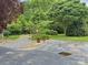 Property featuring an asphalt driveway leading to a carport with a gravel parking area at 104 Tobe Bridge Rd, Kings Mountain, NC 28086
