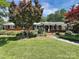 Charming brick home with lush front yard landscaping, mature trees, and inviting curb appeal at 104 Tobe Bridge Rd, Kings Mountain, NC 28086