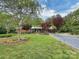Charming single-story brick home with a well-manicured lawn and mature trees at 104 Tobe Bridge Rd, Kings Mountain, NC 28086