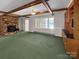 Inviting living room with a brick fireplace, wooden beams, and built-in cabinets at 104 Tobe Bridge Rd, Kings Mountain, NC 28086