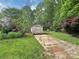 Exterior view of a backyard shed with ample storage space and a paved pathway at 104 Tobe Bridge Rd, Kings Mountain, NC 28086