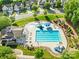 Aerial view of the community pool area featuring a large pool, kiddie pool, and lounge chairs at 10693 Sky Chase Nw Ave, Concord, NC 28027