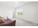 Neutrally decorated bedroom featuring light walls, a window, and neutral carpet at 10693 Sky Chase Nw Ave, Concord, NC 28027