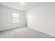 Bright bedroom featuring carpet floors, a window for natural light, and plenty of space for customization at 10693 Sky Chase Nw Ave, Concord, NC 28027