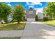 Inviting two-story home with a brick facade, manicured lawn, and a spacious driveway leading to an attached garage at 10693 Sky Chase Nw Ave, Concord, NC 28027