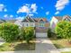 Beautiful two-story home featuring a brick and siding facade, attached garage, and a well-manicured lawn with lush landscaping at 10693 Sky Chase Nw Ave, Concord, NC 28027
