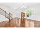 Elegant foyer with hardwood floors, staircase, and ample natural light filtering through the front window at 10693 Sky Chase Nw Ave, Concord, NC 28027