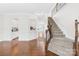 Spacious foyer with hardwood floors, staircase with wrought iron spindles, and elegant trim work at 10693 Sky Chase Nw Ave, Concord, NC 28027