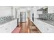 Modern kitchen with stainless steel appliances, granite countertops, and sleek white cabinetry at 10693 Sky Chase Nw Ave, Concord, NC 28027