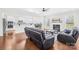 Spacious living area with hardwood floors, fireplace, and an open layout that connects to the kitchen and dining room at 10693 Sky Chase Nw Ave, Concord, NC 28027