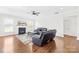 Bright living room features hardwood floors, a fireplace, and comfortable leather seating at 10693 Sky Chase Nw Ave, Concord, NC 28027