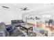 Spacious living area with dark leather sofas, patterned rug, and open view to kitchen and dining at 10693 Sky Chase Nw Ave, Concord, NC 28027