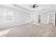 Light-filled primary bedroom with tray ceiling, ceiling fan, and ensuite bathroom access offers privacy and comfort at 10693 Sky Chase Nw Ave, Concord, NC 28027