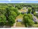 Aerial view of a charming one-story home surrounded by lush trees in a quiet neighborhood at 109 Jackson St, Salisbury, NC 28144