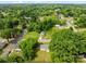 An aerial view of a one-story home nestled within a vibrant green, tree-filled neighborhood at 109 Jackson St, Salisbury, NC 28144