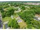 An aerial view of a one-story home nestled within a vibrant green, tree-filled neighborhood at 109 Jackson St, Salisbury, NC 28144