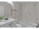Bright bathroom featuring tiled shower over tub and sleek vanity with a framed mirror at 109 Jackson St, Salisbury, NC 28144