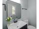 Bathroom featuring a white vanity with dark hardware and framed mirror offering ample lighting at 109 Jackson St, Salisbury, NC 28144