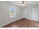 Bedroom with wood-look floors, ceiling fan, and window at 109 Jackson St, Salisbury, NC 28144