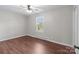 Bright bedroom with ceiling fan, wood-look flooring, and window at 109 Jackson St, Salisbury, NC 28144