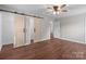 Large bedroom featuring wood-look floors, ceiling fan and sliding barn doors to closet or bath at 109 Jackson St, Salisbury, NC 28144