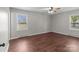 Spacious bedroom with two windows, ceiling fan, and wood-look floors, providing natural light at 109 Jackson St, Salisbury, NC 28144