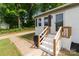 Stylish home entrance with brick stairs, wooden railings, and black mulch at 109 Jackson St, Salisbury, NC 28144