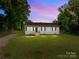 Charming one-story home with a well-maintained lawn and inviting entrance at dusk at 109 Jackson St, Salisbury, NC 28144