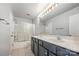 A full bathroom featuring a double vanity with a white countertop and framed mirror at 10901 Claude Freeman Dr, Charlotte, NC 28262