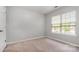 Bedroom with carpet flooring, light grey walls, and natural light from a window at 10901 Claude Freeman Dr, Charlotte, NC 28262