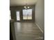 Bright dining area featuring wood floors, large windows, and natural light at 10901 Claude Freeman Dr, Charlotte, NC 28262