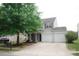Charming two-story home with a well-maintained front yard and an attached two-car garage at 10901 Claude Freeman Dr, Charlotte, NC 28262