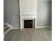 Cozy living room featuring a fireplace, wood floors, and stairs to the next floor at 10901 Claude Freeman Dr, Charlotte, NC 28262
