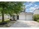 Charming two-story home boasts a well-manicured lawn and two-car garage at 10901 Claude Freeman Dr, Charlotte, NC 28262