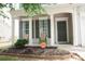 A cozy front porch featuring decorative columns, a flower bed, and an CPI security sign at 10901 Claude Freeman Dr, Charlotte, NC 28262
