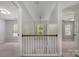 Bright upstairs hallway featuring pendant lighting, and views into adjacent bedrooms and window at 10901 Claude Freeman Dr, Charlotte, NC 28262