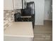A clean kitchen featuring light countertops, and black appliances at 10901 Claude Freeman Dr, Charlotte, NC 28262