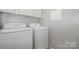 Neat laundry room with modern washer and dryer units, designed for efficient laundry tasks at 10901 Claude Freeman Dr, Charlotte, NC 28262