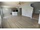Open-concept living room featuring wood floors, a kitchen bar, and natural light at 10901 Claude Freeman Dr, Charlotte, NC 28262