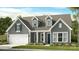 Charming two-story home with blue door, attached garage, and a well-manicured lawn at 1099 Sugar Creek Rd, Indian Land, SC 29707