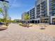 Outdoor plaza area with seating, a walkway, and retail buildings with multiple floors and businesses at 1099 Sugar Creek Rd, Indian Land, SC 29707