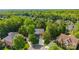 An aerial view of a charming neighborhood with tree-lined streets and well-manicured lawns at 1108 Longwood Ct, Matthews, NC 28104