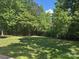 Lush backyard featuring meticulously manicured lawn and perimeter landscaping, creating a private outdoor sanctuary at 1108 Longwood Ct, Matthews, NC 28104