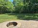 A spacious, well-maintained backyard features a stone patio and a built-in fire pit for outdoor gatherings at 1108 Longwood Ct, Matthews, NC 28104