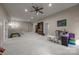 Large carpeted basement with ceiling fan, a play area and a bookshelf at 1108 Longwood Ct, Matthews, NC 28104
